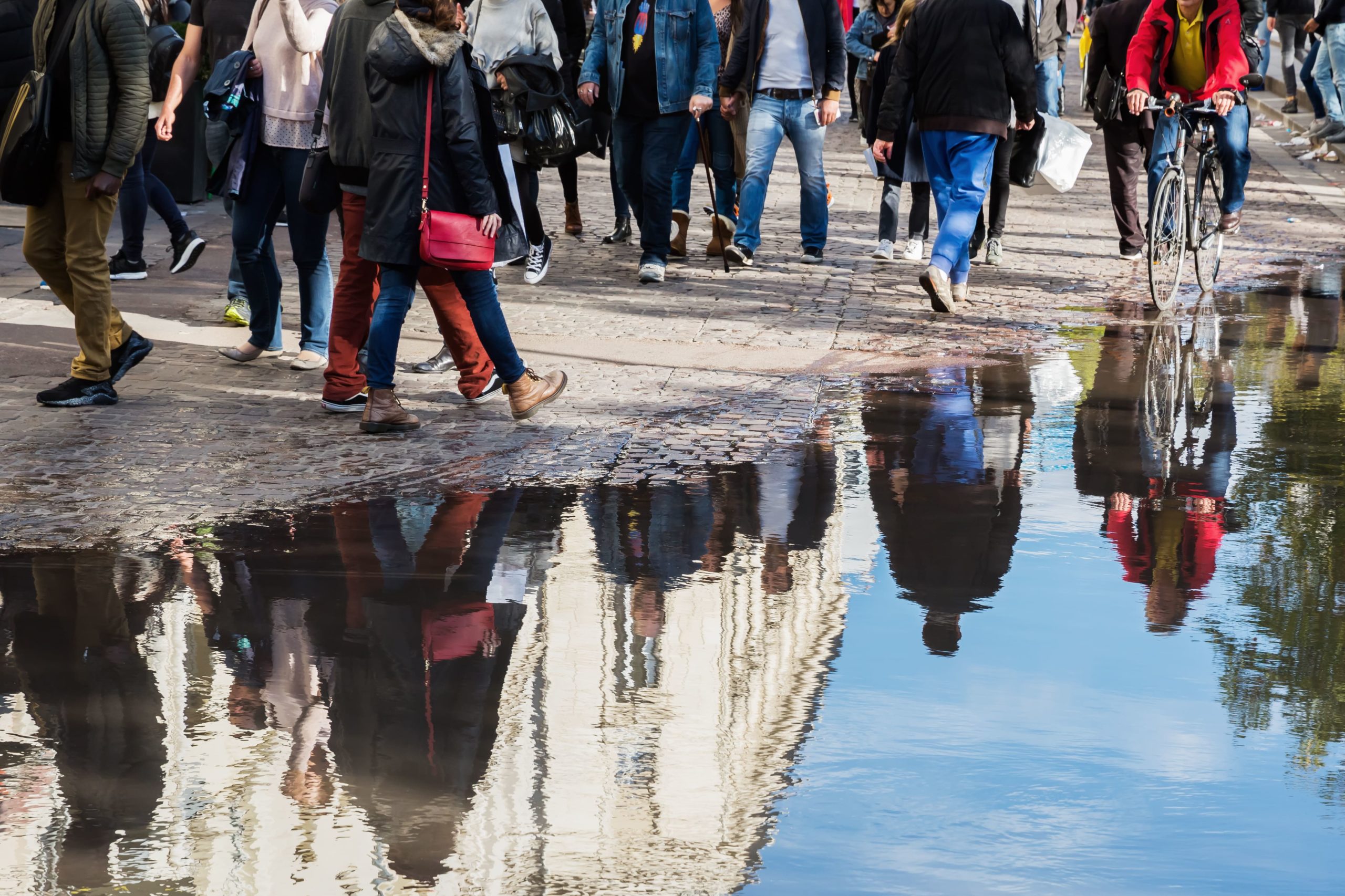 people-reflected-in-puddle-scaled