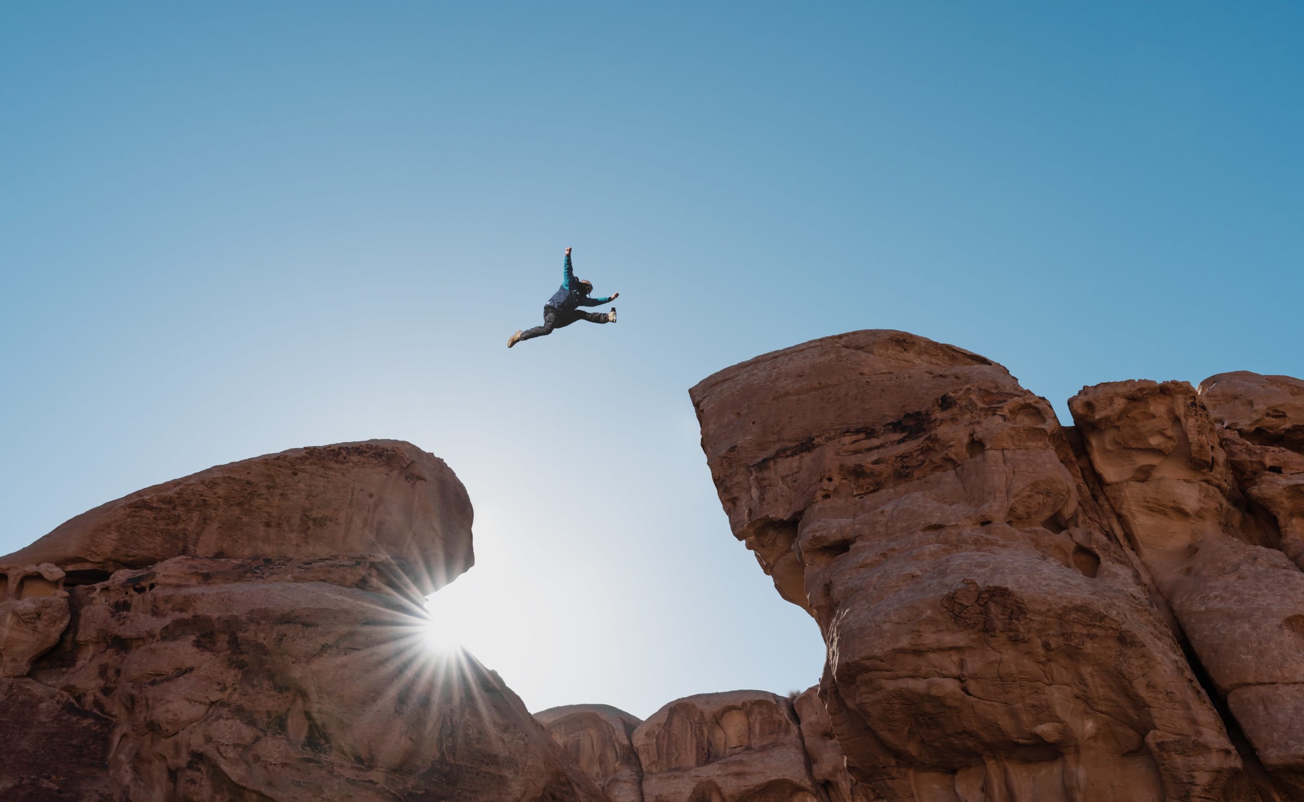 Silhouette Man Jumping Over Precipice Crossing Cliff Scaled