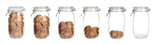 Cookies in a row of jars with each jar emptier than the last